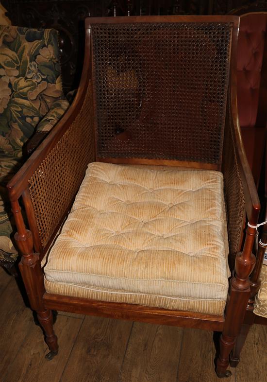 An Edwardian Sheraton style satinwood bergere armchair, W.2ft D.2ft 5in. H.3ft 3in.